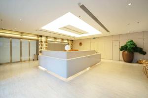 a large lobby with a skylight in a building at JI Hotel Beijing Changyang Subway Station in Fangshan