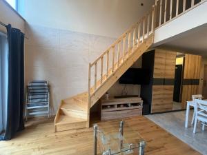 a living room with a staircase and a table at Apartament Na Wspólnej in Łeba