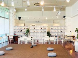 a store with white chairs and a table in a room at Bridge Hotel Incheon Songdo in Incheon