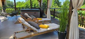 a patio with couches and a fire place at Studio apartman King with private jacuzzi and sauna in Štakorovec