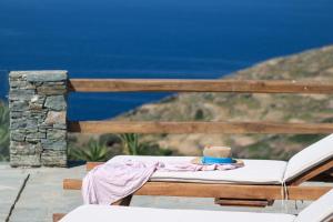 a hat is sitting on a bed on a deck at Taeri Sifnos in Sifnos