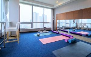a fitness room with yoga mats and a large window at Bridge Hotel Incheon Songdo in Incheon
