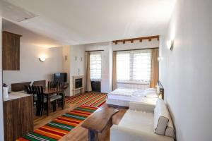 a living room with a couch and a dining room at Студио in Starosel
