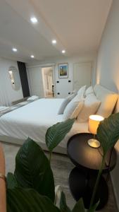 a bedroom with a large white bed and a table at Casa Nika in Parma