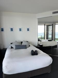 a bedroom with two beds with towels on them at Newcastle Beach Escape in Newcastle