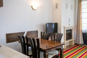 a dining room with a wooden table and chairs at Студио in Starosel