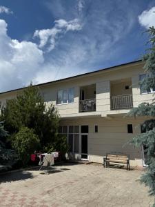a building with a bench in front of it at HOTEL Vzmorye in Bosteri