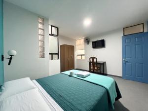 a bedroom with a bed with a blue door at Dream Place Trujillo in Trujillo