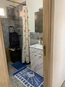 a bathroom with a sink and a shower curtain at Atlas Nest in Beni Mellal