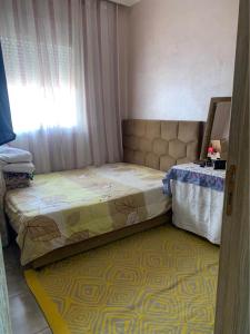 a small bed in a room with a window at Atlas Nest in Beni Mellal