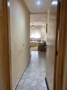 a hallway leading to a living room with a bedroom at Atlas Nest in Beni Mellal +2 photos