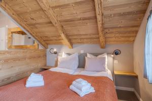 a bedroom with a bed with two towels on it at Buche in Interlaken