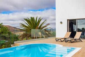 a villa with a swimming pool and a patio at Playitas Hotel - Sports Resort in Las Playitas +92 photos