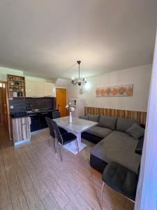 a living room with a couch and a table at Apartma Jelenček in Moravske-Toplice