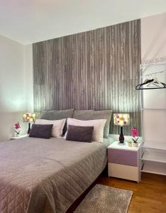 a bedroom with a large bed with two lamps at Villa Kiki in Bol