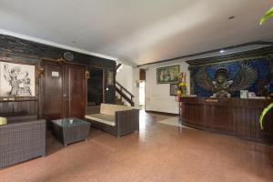 a room with a staircase and a wall with a mural at Taman Ayu Legian Hotel in Legian +147 photos