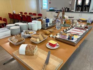a long table with bread and other food on it at Lyngmo Gjestehus in Hafslo