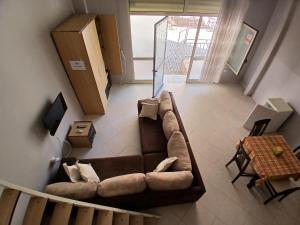 a living room with a couch and a table at Proper Apartment in Vlorë