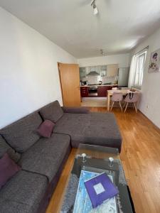 a living room with a couch and a table at Apartman S & S in Makarska