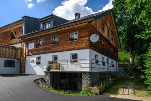 a large wooden building with a clock on it at Ferienwohnung Rief in Tannheim