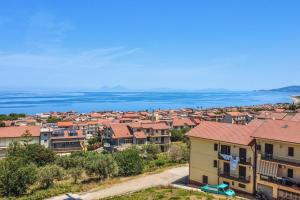 a city with houses and the ocean in the background at Casa Vacanze Panoramics in Acquedolci