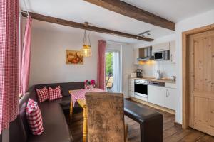 a kitchen and living room with a couch and a table at Ferienhof Pohl-Optimal für Familien in Lennestadt