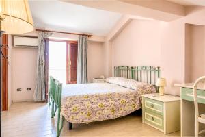 a bedroom with a bed and a window at Casa Vacanze Panoramics in Acquedolci