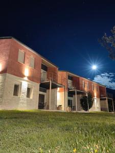 a building at night with the moon in the sky at Zois Apartment in Gliki +1 photo