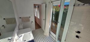 a white bathroom with a sink and a shower at Beach side studio Quindalup in Quindalup