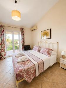 a bedroom with a large bed and a window at Maison See View in Kontokali