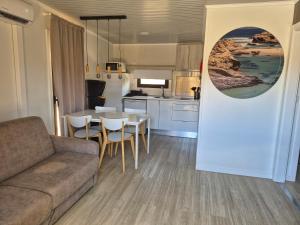 a living room with a couch and a table and chairs at São Torpes by Campigir in Sines +24 photos