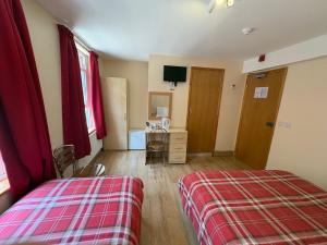 a bedroom with a bed and a dresser and a mirror at Seven Dials Hotel in London
