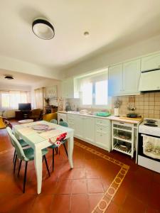 a kitchen with a table and chairs in a room at Maison See View in Kontokali