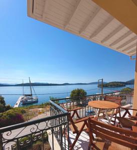a balcony with tables and a view of a boat at Irene Studios in Nydri