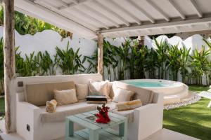 a living room with a couch and a pool at Villa Norte in Gili Islands