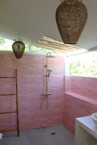 a pink tiled bathroom with a shower and a sink at Villa Norte in Gili Islands +31 photos