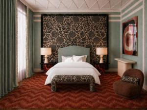 a bedroom with a large bed and a chair at Hotel Club 29 in Barcelona