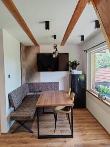a dining room with a wooden table and a bench at Chalet Zasavka in Dol pri Hrastniku +23 photos