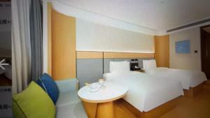 a room with a white table and a room with a couch at JI Hotel Beijing Huilongguan in Changping +28 photos