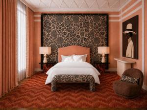 a bedroom with a large bed and a chair at Hotel Club 29 in Barcelona