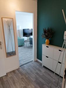 a living room with a mirror and a dresser at Chambre dans colocation à Lormont proche Bordeaux in Lormont