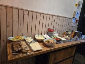 a table with many different types of food on it at Bat Galim Boutique Hotel in Haifa