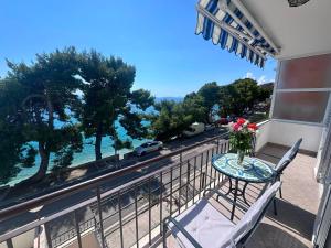 a balcony with a table and chairs and a view of a street at Apartment Verica in Krilo +19 photos