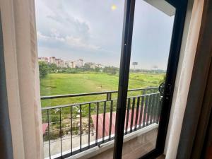 a window view of a field from a balcony at Family Transit Hotel in Thach Loi