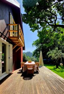 a wooden deck with a table on top of a building at Ferreirinha Valley in Vieira do Minho