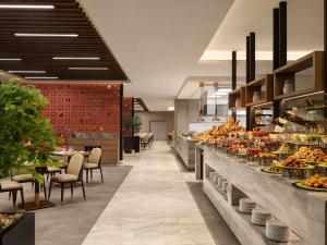 a bakery with a buffet of fruits and vegetables at Movenpick Hotel & Residences Hajar Tower Makkah in Mecca