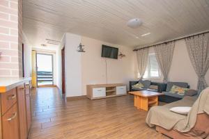 a living room with a couch and a table at Apartment Marin in Tkon