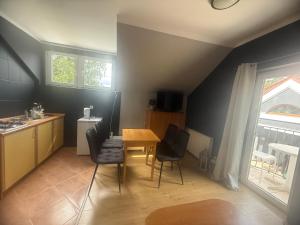 a kitchen with a table and chairs in a room at Korab Wisełka & SPA in Wisełka