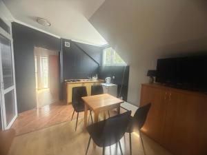 a kitchen with a table and chairs in a room at Korab Wisełka & SPA in Wisełka
