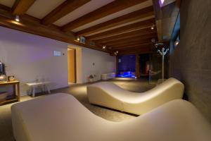 a living room with a white couch in a room at Hotel Edelweiss 3 Stelle SUPERIOR in Breuil-Cervinia